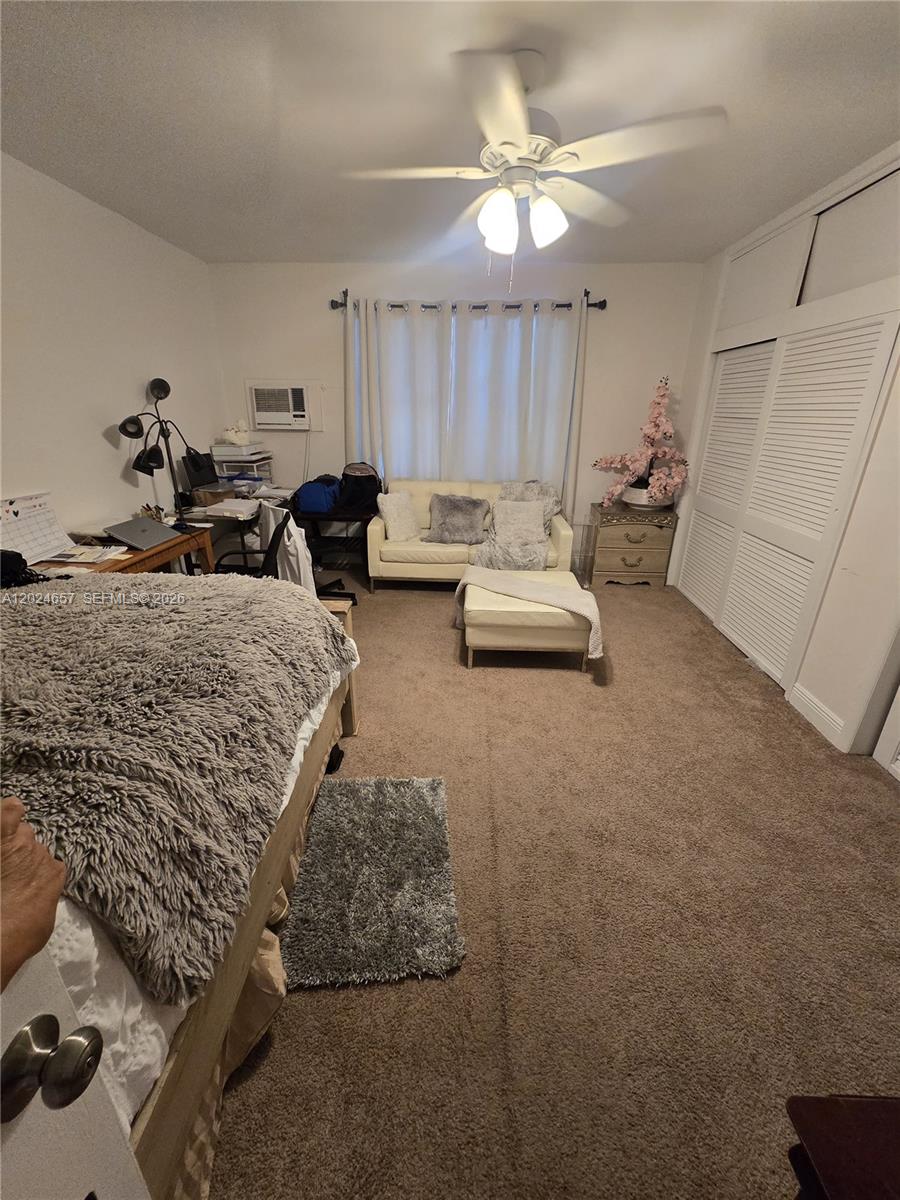 3619 West Park Road Hollywood, FL 33021 - Photo 15 of 19 a bed room with furniture and a chandelier
