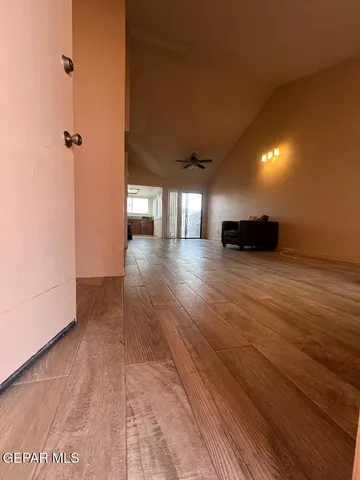a view of an empty room with wooden floor