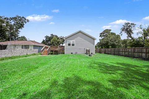 a view of house with backyard