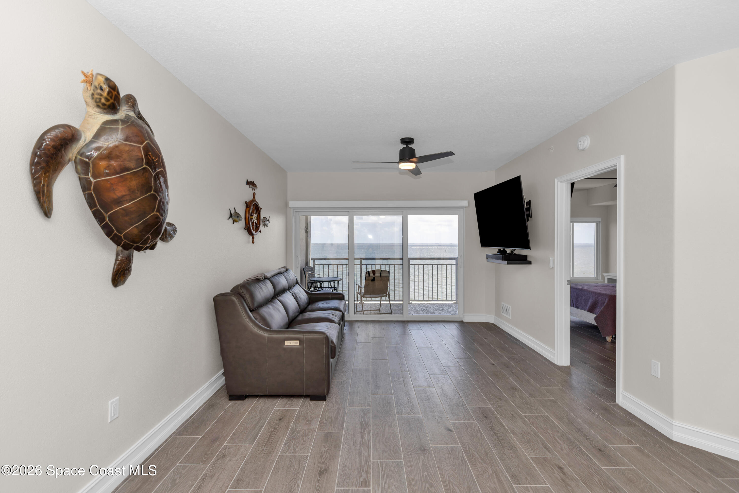 1805 Riverside Drive, Unit 506 Titusville, FL 32780 - Photo 8 of 24 a living room with furniture and a flat screen tv