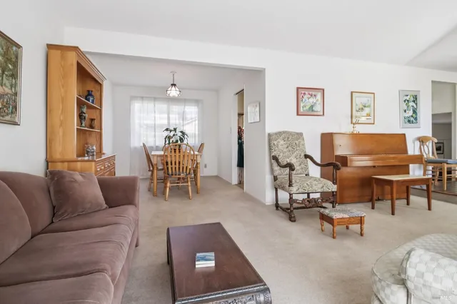 a living room with furniture and a floor to ceiling window
