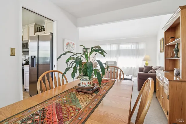 a kitchen with stainless steel appliances a counter top space cabinets and a potted plant