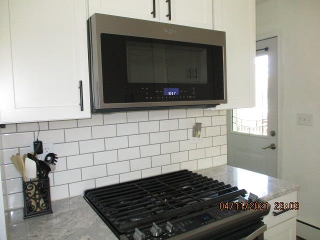 3918 Pinecrest Road Rockford, IL 61107 - Photo 11 of 21 a kitchen with a stove and a microwave