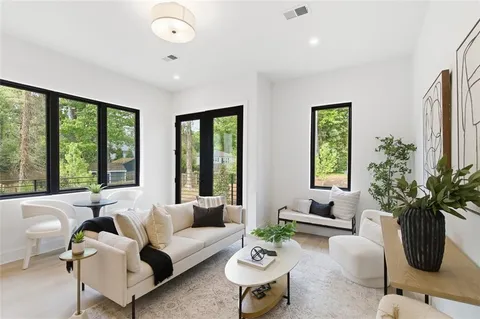a living room with furniture potted plant floor and a window