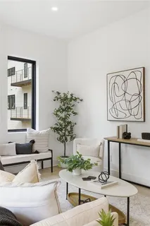 a living room with furniture and paintings