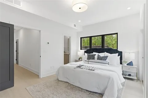 a bedroom with a large bed and a large window