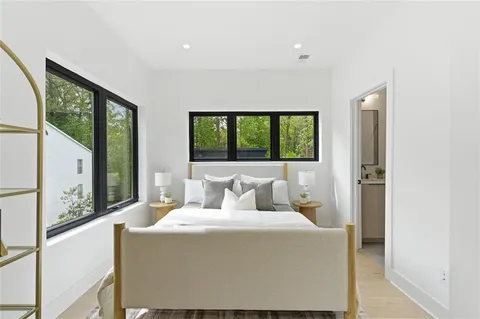 a bedroom with a large bed and a large window