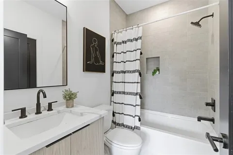 a bathroom with a sink toilet and shower