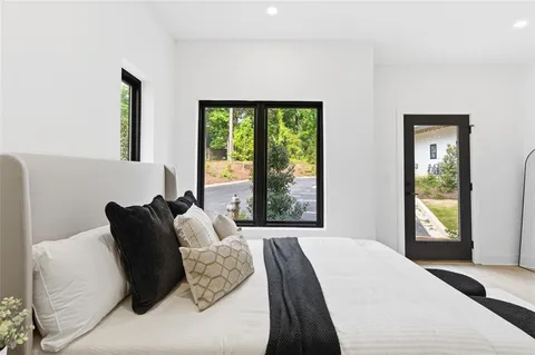 a bedroom with a bed and a large window