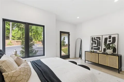 a bed room with a bed and a large window