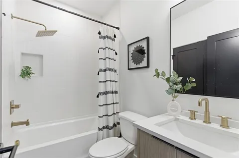 a bathroom with a sink toilet and shower