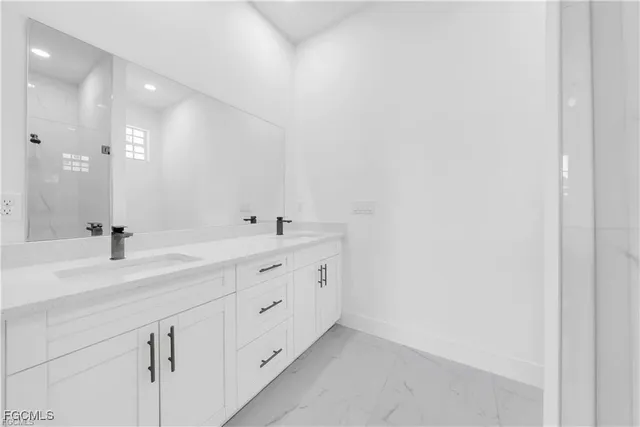 a bathroom with a double vanity sink and mirror