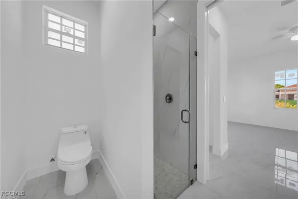 a bathroom with a toilet sink and shower