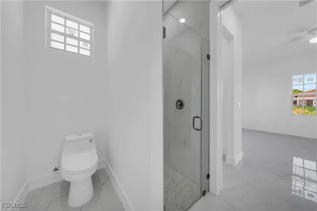 a bathroom with a toilet sink and shower