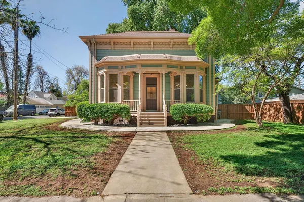 a view of a brick house with a yard