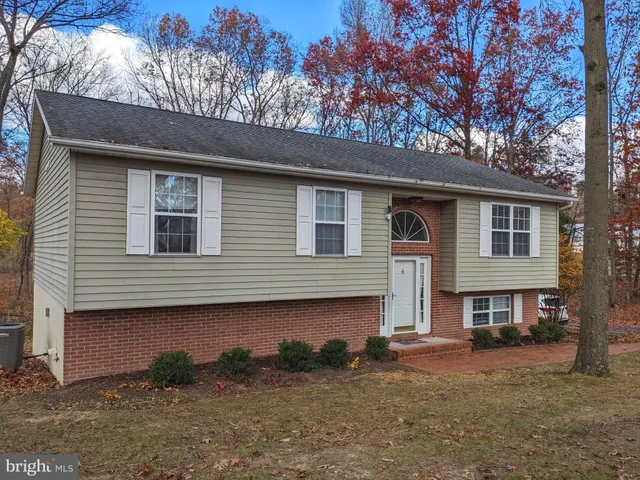 a house that has a tree in front of it