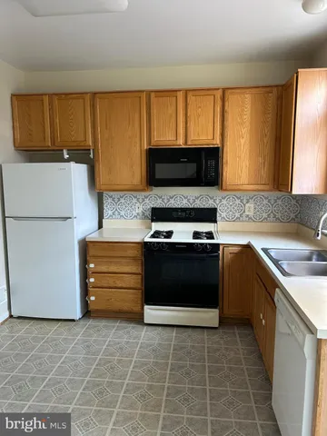a kitchen with a stove and a microwave