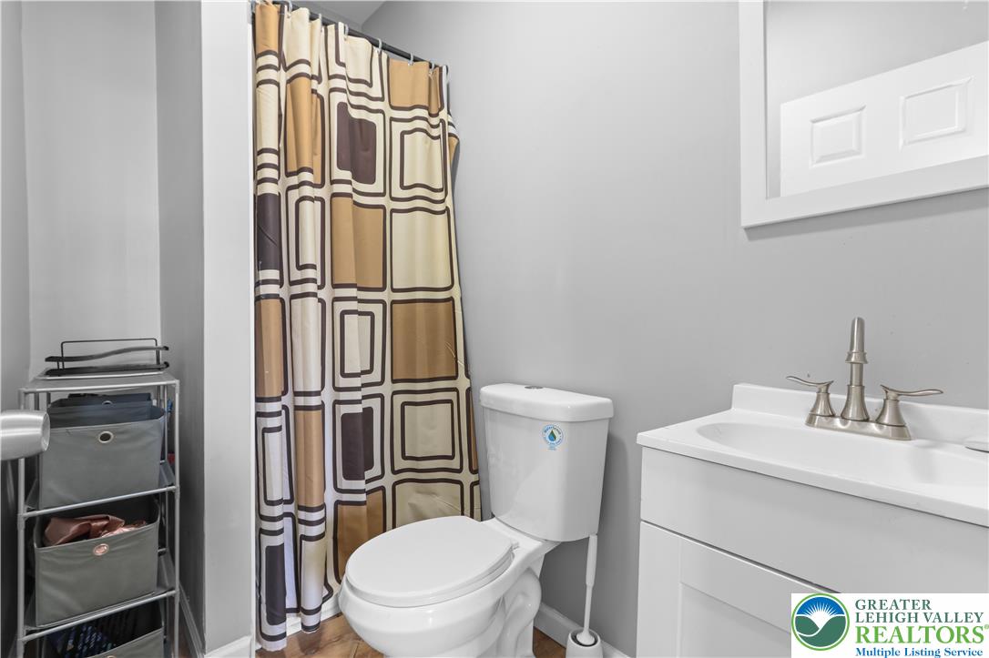 12 South Front Street Coplay, PA 18037 - Photo 30 of 41 This bright bathroom features a functional vanity and a clean, inviting aesthetic.