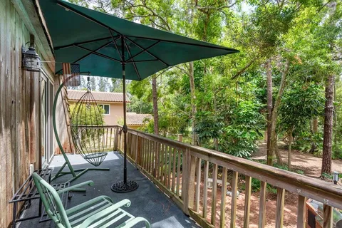 a room with furniture a large window and a wooden floor