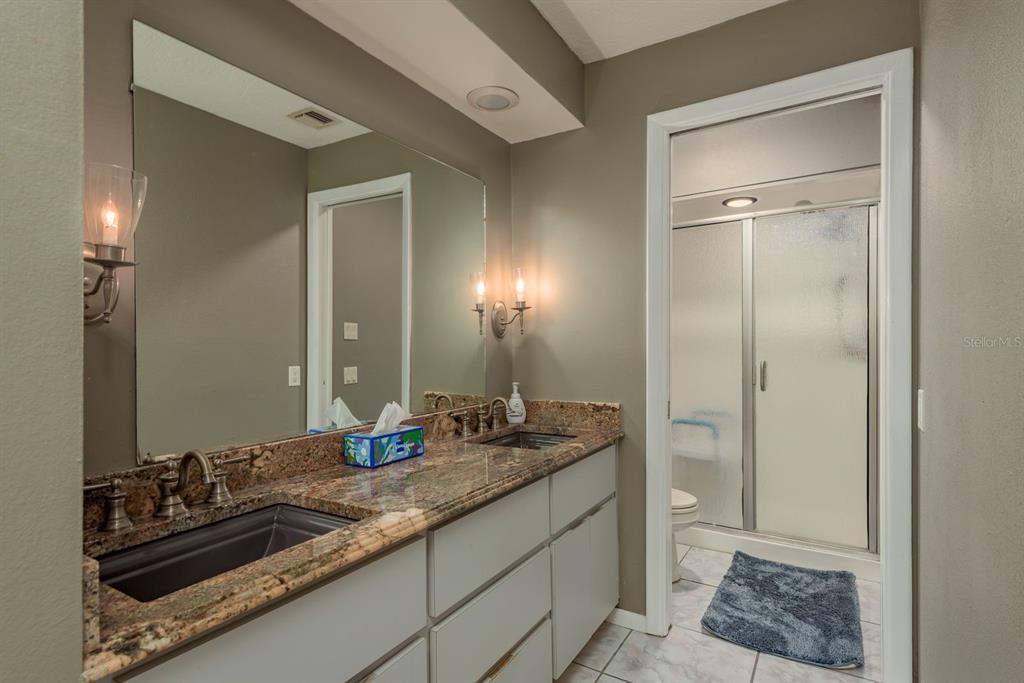 2279 Ranchette Lane Dunedin, FL 34698 - Photo 34 of 50 a bathroom with a sink and a mirror