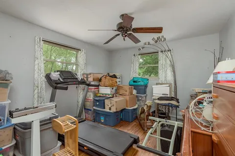 a view of a patio with chairs and plants