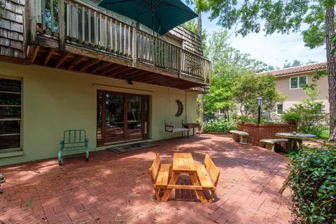 a view of a bedroom with a bed and a window