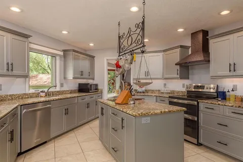 a view of a deck with a table and chairs under an umbrella with a small yard