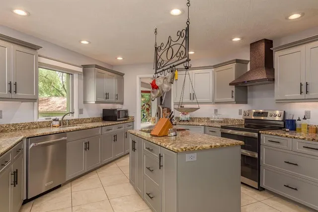 a view of a deck with a table and chairs under an umbrella with a small yard