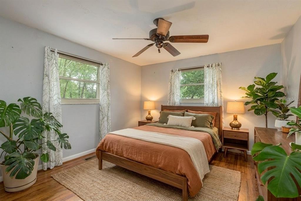 2279 Ranchette Lane Dunedin, FL 34698 - Photo 6 of 50 a bedroom with a bed table flowerpot and window