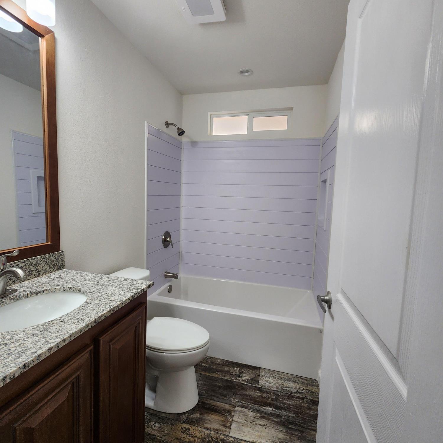 350 Pleasant Valley Road, Unit 49 Diamond Springs, CA 95619 - Photo 12 of 13 a bathroom with a granite countertop sink toilet a mirror and bathtub