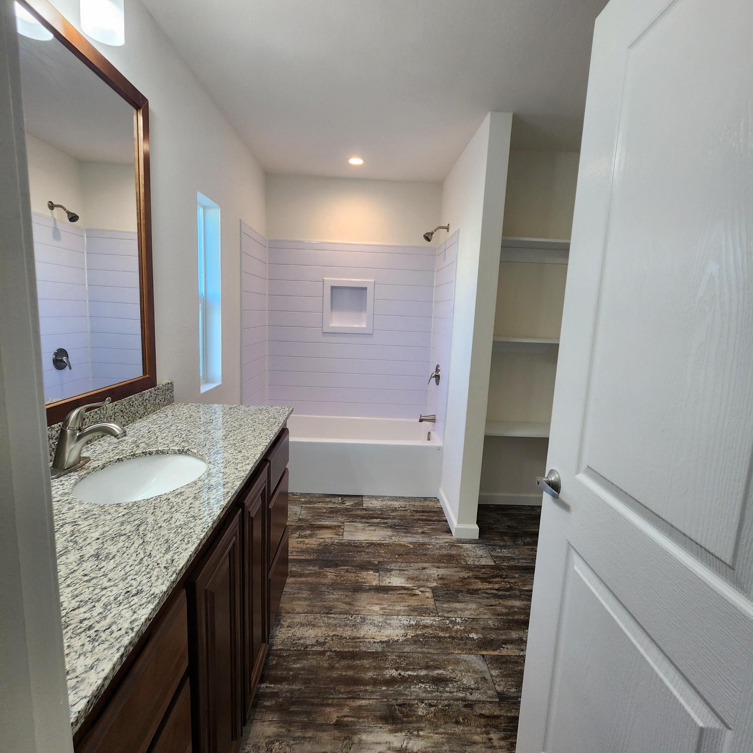 350 Pleasant Valley Road, Unit 49 Diamond Springs, CA 95619 - Photo 7 of 13 a bathroom with a granite countertop sink and a mirror