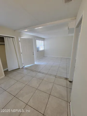 a view of an empty room and a window