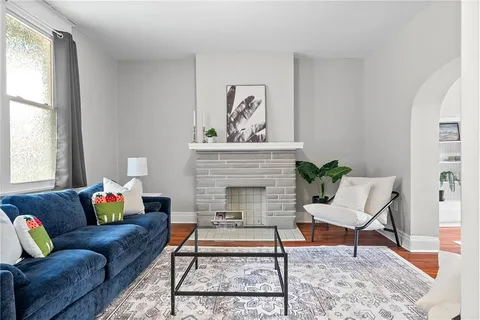 a living room with furniture and a fireplace