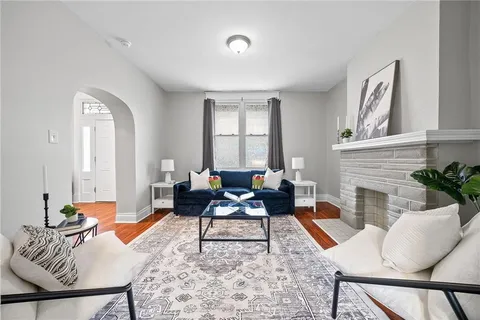 a living room with furniture and a fireplace
