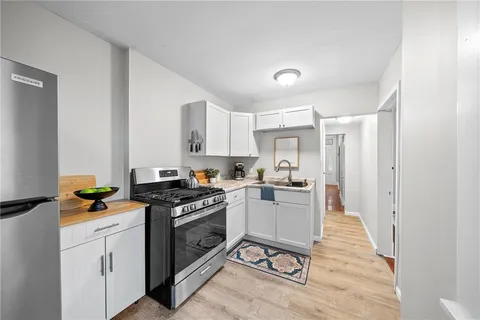 a kitchen with a stove a sink and a refrigerator