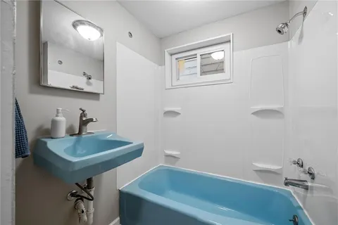 a bathroom with a sink a toilet and tub