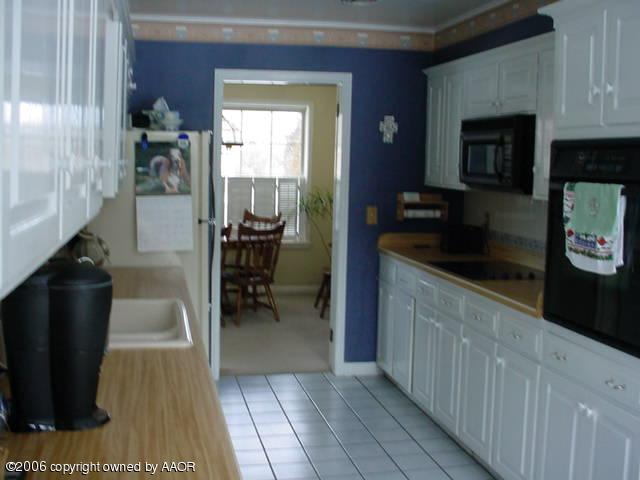 6303 Gainsborough Road Amarillo, TX 79106 - Photo 5 of 12 a kitchen with a sink and cabinets