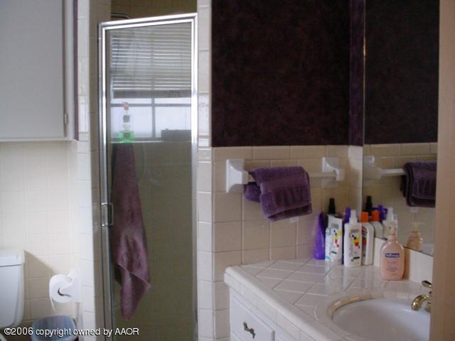 6303 Gainsborough Road Amarillo, TX 79106 - Photo 10 of 12 a bathroom with a sink and a mirror
