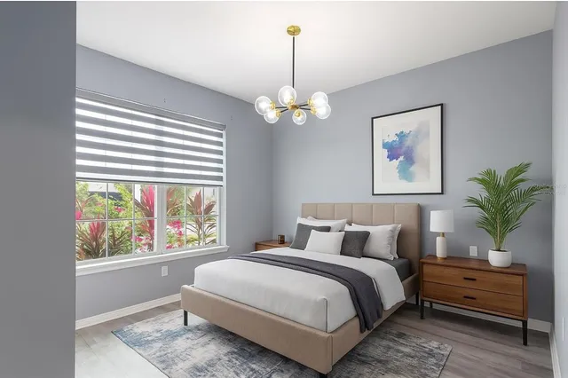 a bedroom with a bed and a window