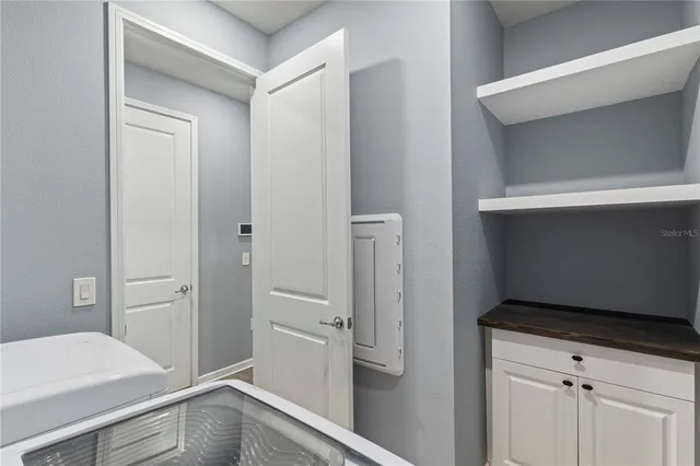 a view of storage and utility room with closet