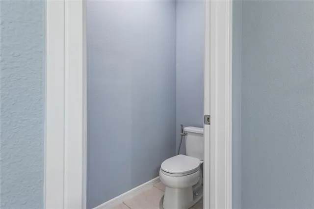 a white toilet sitting next to a white cabinet