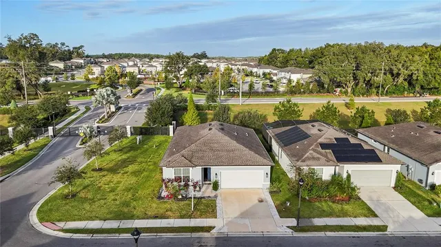 an aerial view of a house with outdoor space
