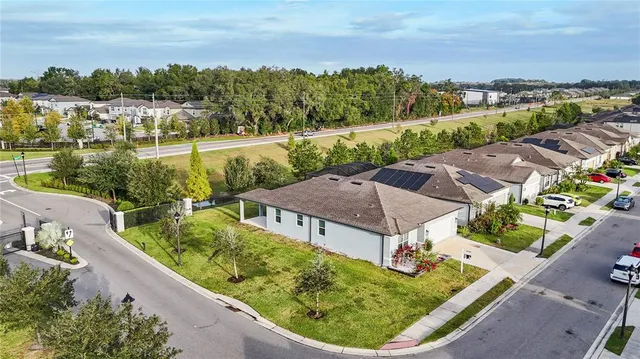 an aerial view of a house with garden space and street view