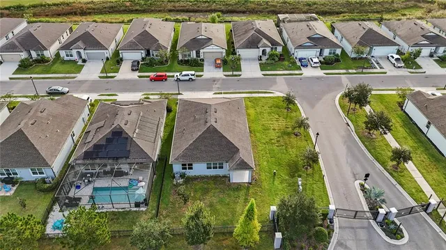 an aerial view of residential house with outdoor space and swimming pool