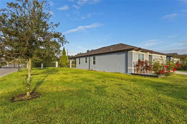 a view of a house with backyard and sitting area