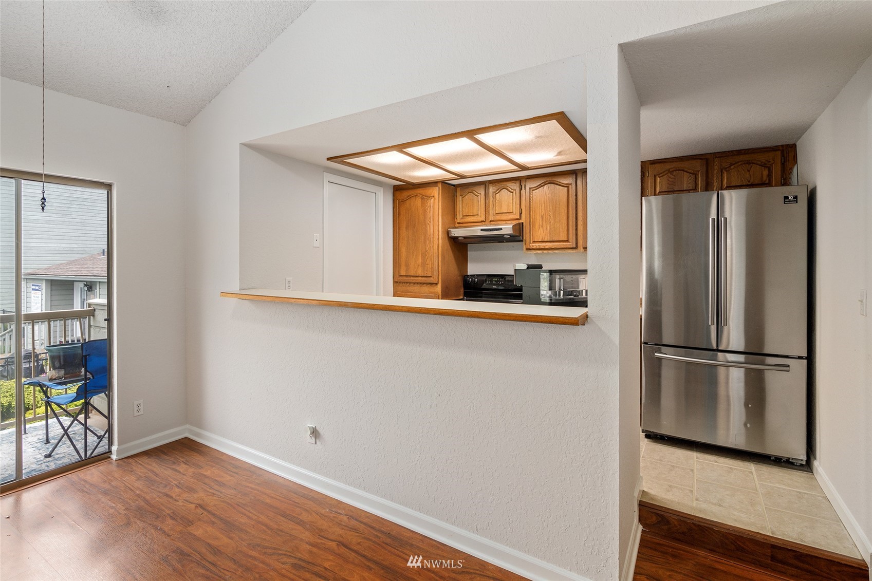 14401 Southeast Petrovitsky Road, Unit G203 Renton, WA 98058 - Photo 8 of 25 a kitchen with stainless steel appliances a refrigerator and microwave