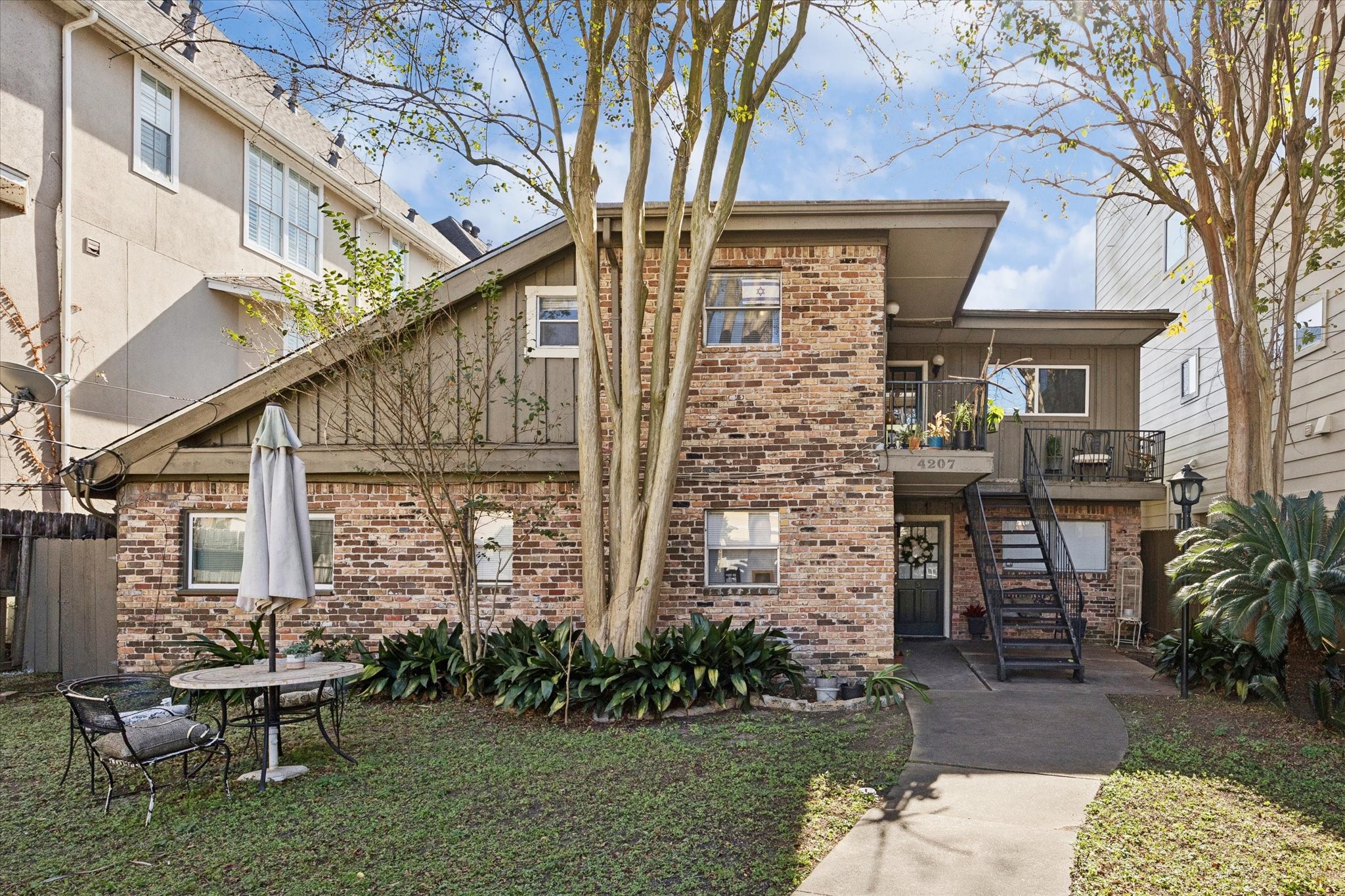 4207 Drake Street Houston, TX 77005 - Photo 2 of 24 a front view of a house with garden