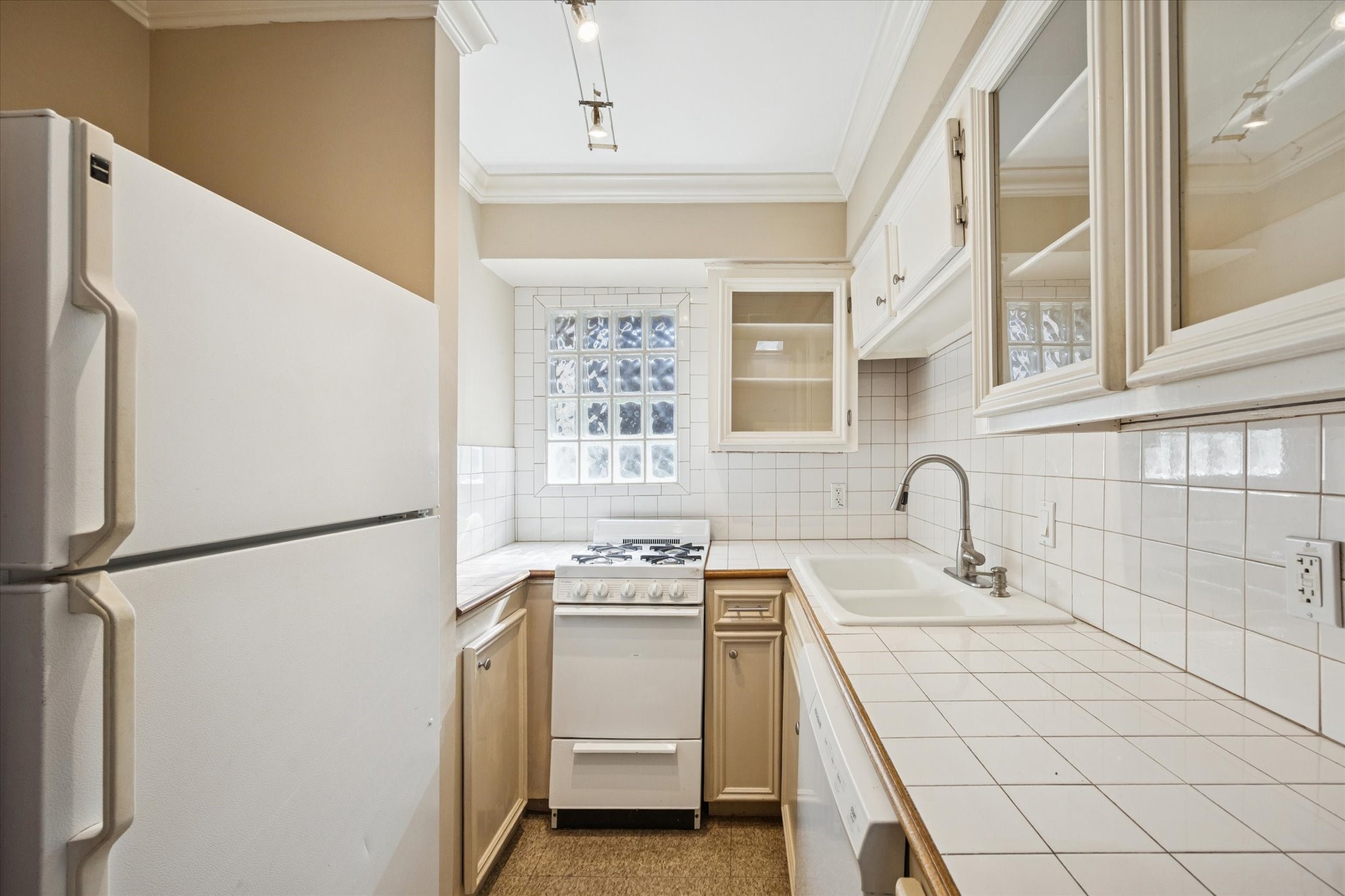 4207 Drake Street Houston, TX 77005 - Photo 8 of 24 a view of a kitchen with white cabinets and white appliances