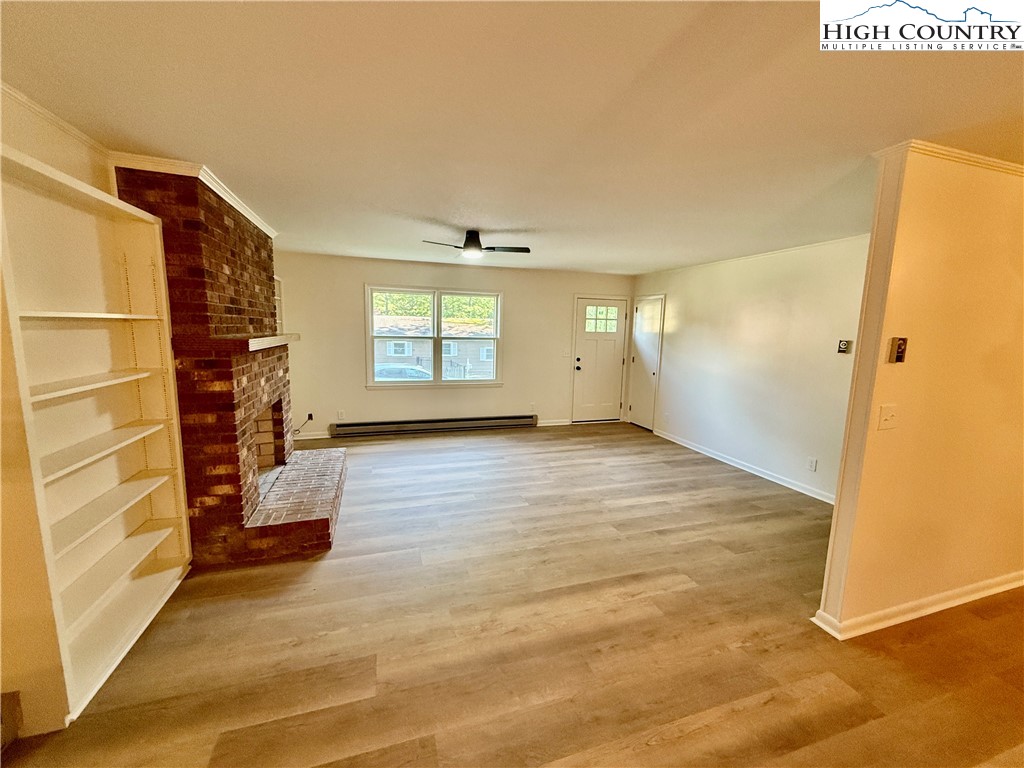 130 Maple Drive Boone, NC 28607 - Photo 11 of 21 an empty room with wooden floor and windows