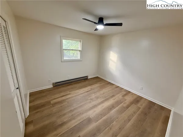 an empty room with a empty space and windows